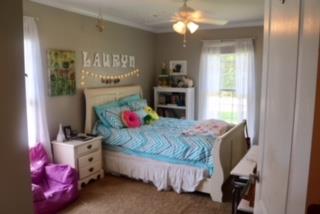 475 Tom Grissom Road Morrison, TN 37357 - Photo 12 of 17 a bedroom with a bed and a chandelier