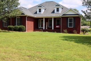 475 Tom Grissom Road Morrison, TN 37357 - Photo 2 of 17 a front view of a house with a yard and garage