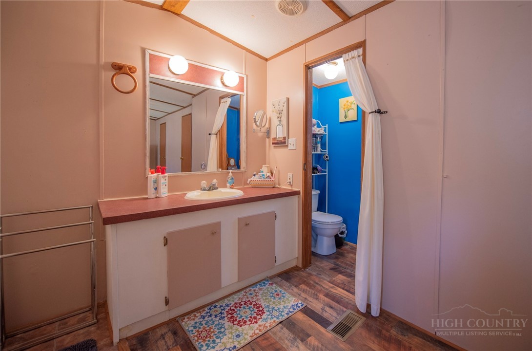 1848 West Mill Creek Road Warrensville, NC 28693 - Photo 34 of 50 a bathroom with a double vanity sink and a mirror