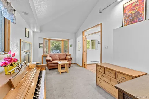 a living room with furniture and flowers