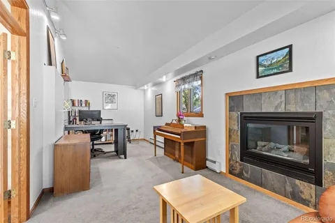 a living room with furniture a window and a fireplace