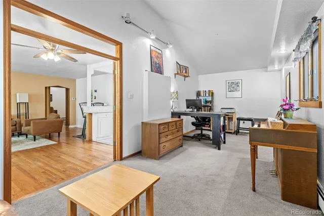 a living room with furniture and a dining table with projector the view