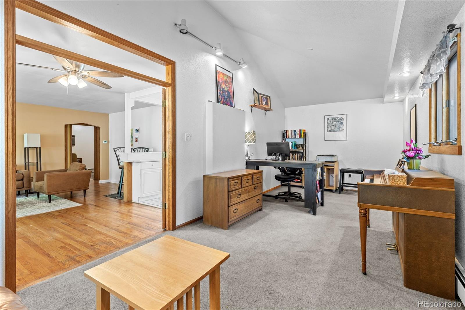 1732 Lansing Street Aurora, CO 80010 - Photo 13 of 37 a living room with furniture and a dining table with projector the view
