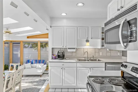 a kitchen with furniture a stove and a sink