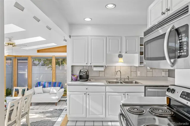 a kitchen with furniture a stove and a sink