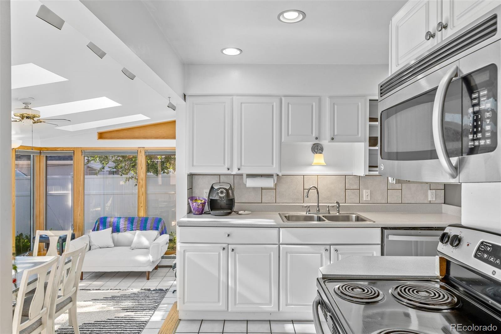 1732 Lansing Street Aurora, CO 80010 - Photo 20 of 37 a kitchen with furniture a stove and a sink