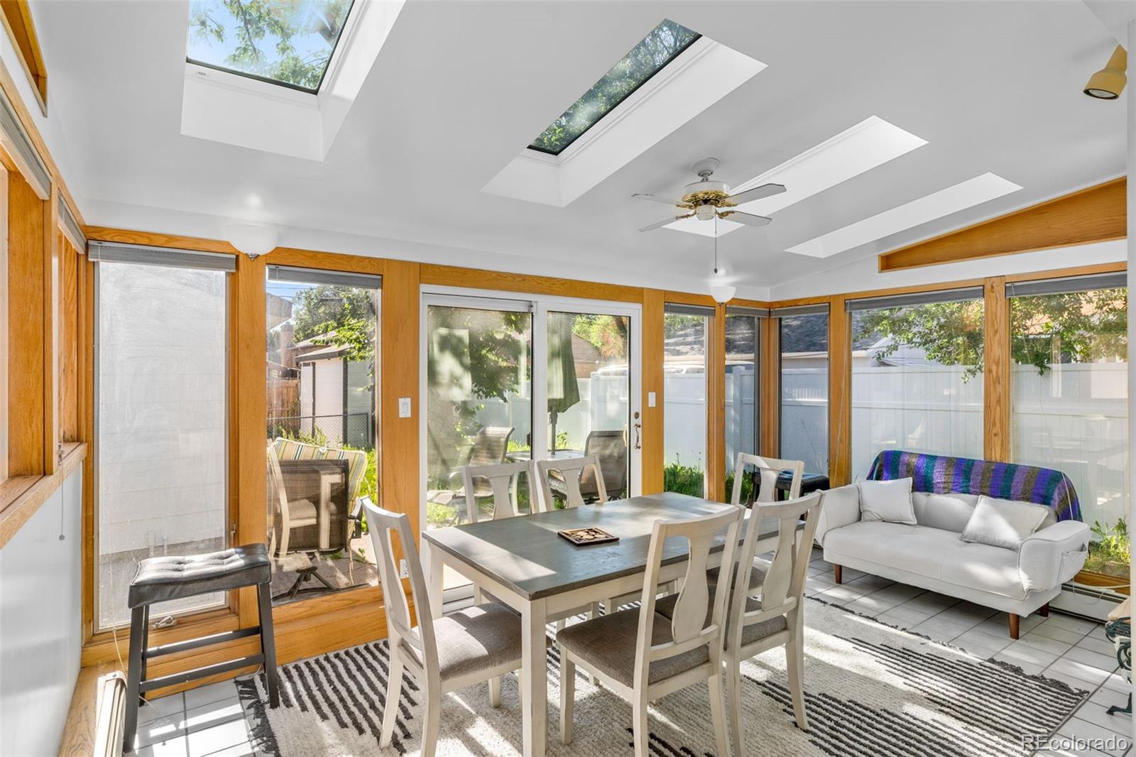 1732 Lansing Street Aurora, CO 80010 - Photo 22 of 37 a living room with furniture a ceiling fan and a large window