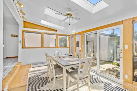 a view of a dining room with furniture wooden floor and a chandelier