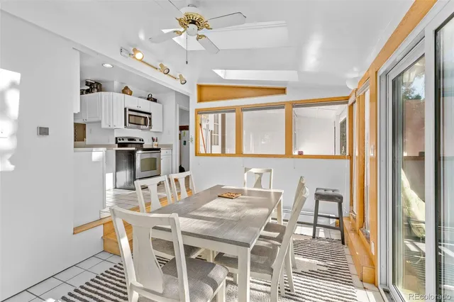 a view of a dining room with furniture and a chandelier