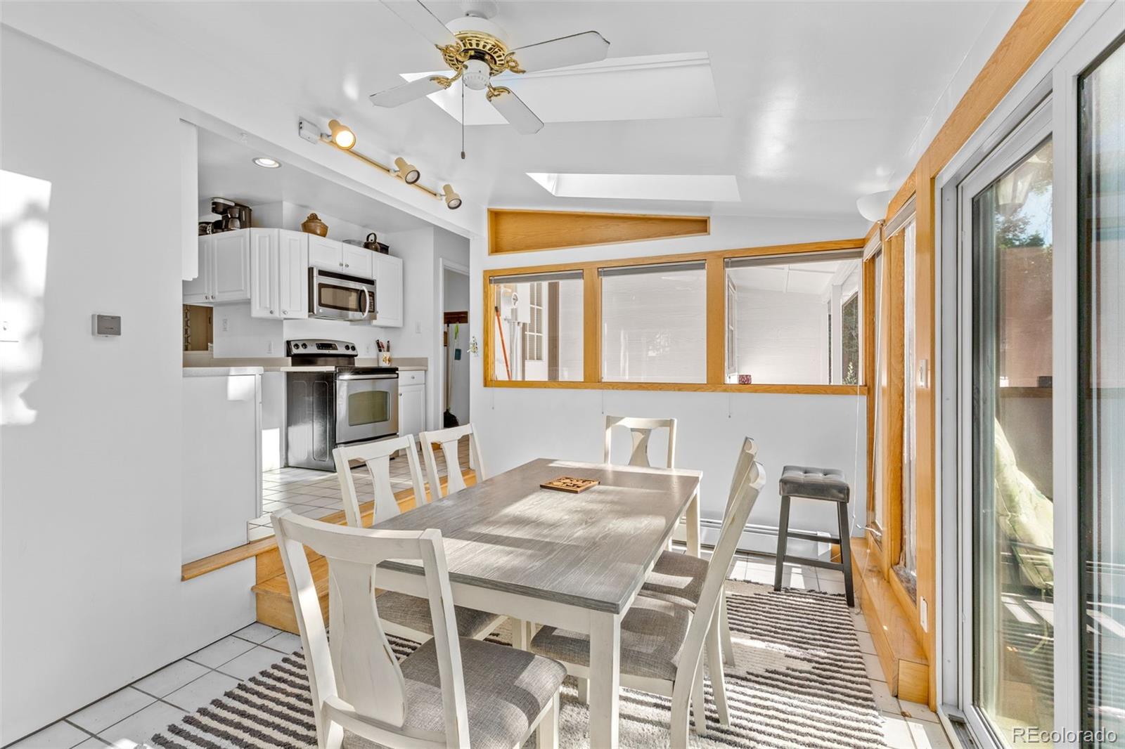 1732 Lansing Street Aurora, CO 80010 - Photo 25 of 37 a view of a dining room with furniture and a chandelier