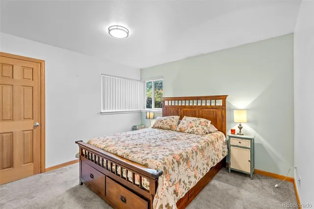 a bedroom with a bed and a night stand