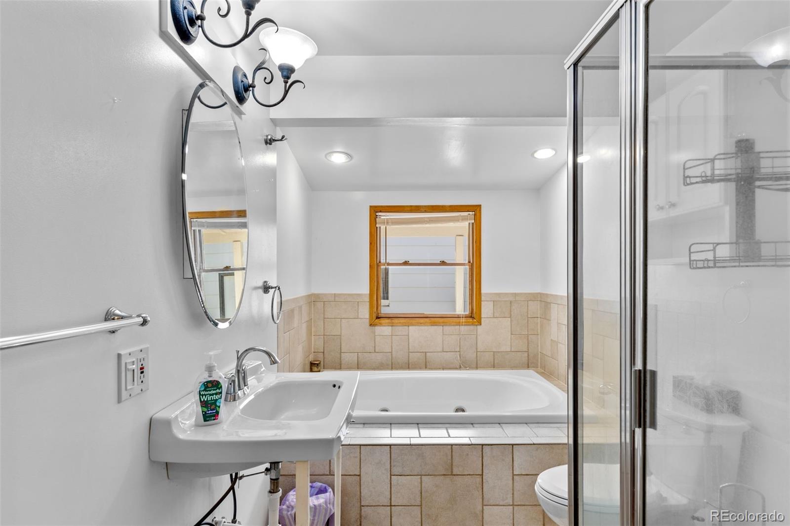 1732 Lansing Street Aurora, CO 80010 - Photo 30 of 37 a bathroom with a bathtub and a sink