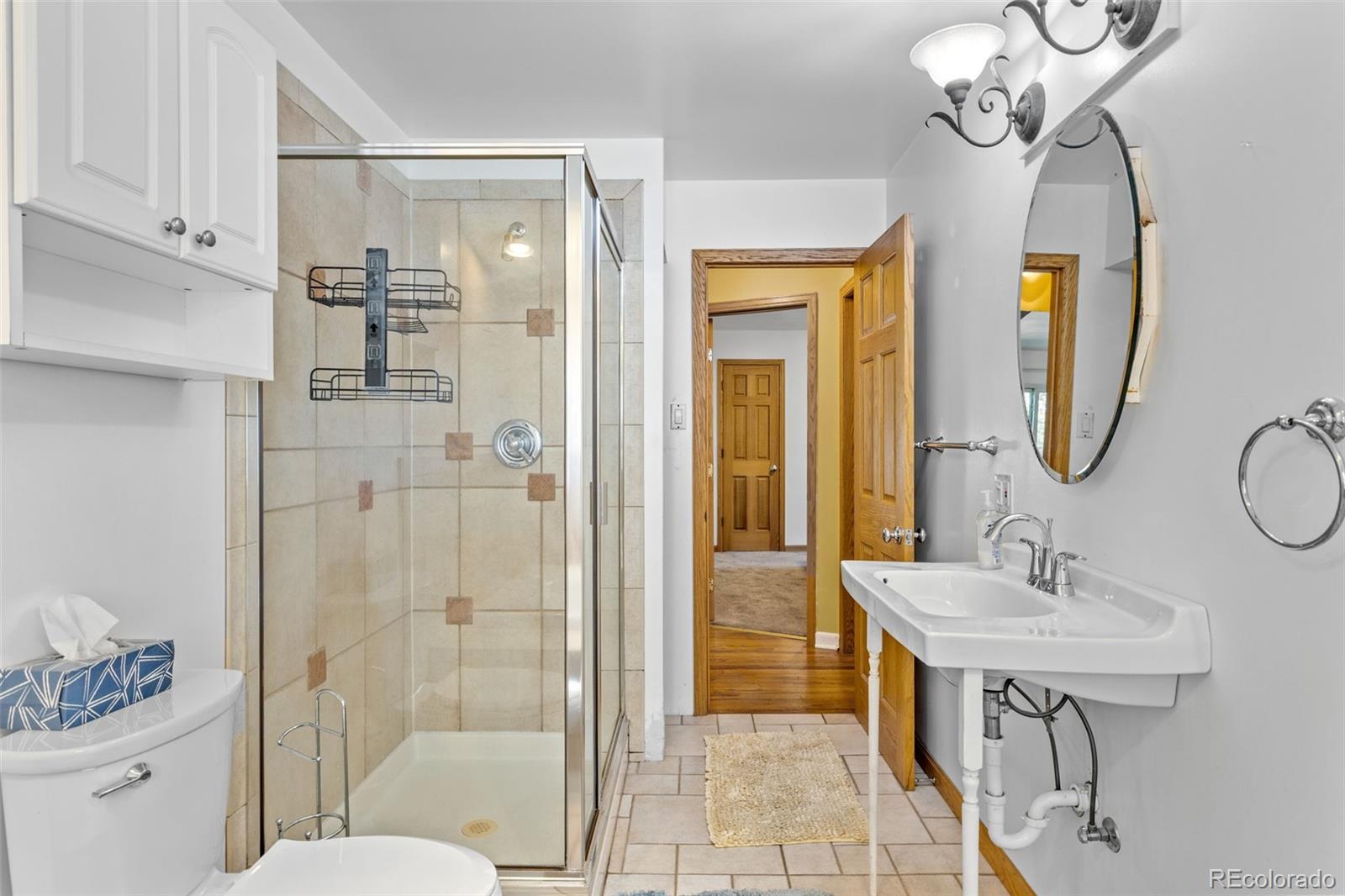 1732 Lansing Street Aurora, CO 80010 - Photo 31 of 37 a bathroom with a sink a toilet and shower