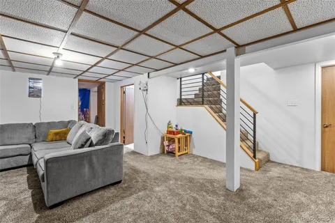 a living room with furniture and a gym