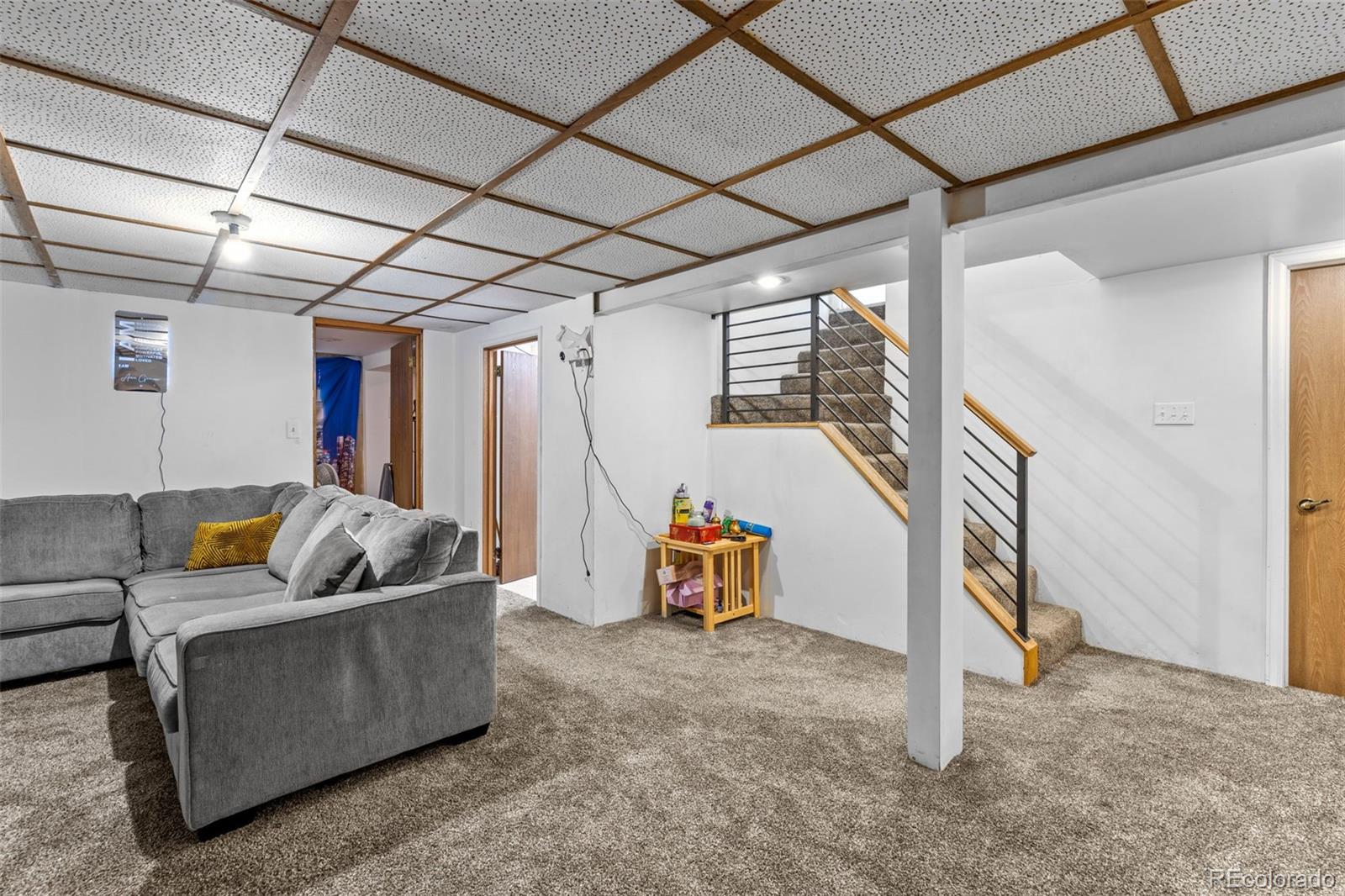 1732 Lansing Street Aurora, CO 80010 - Photo 33 of 37 a living room with furniture and a gym