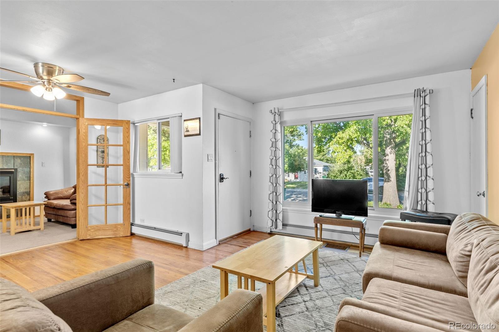1732 Lansing Street Aurora, CO 80010 - Photo 8 of 37 a living room with furniture and a flat screen tv