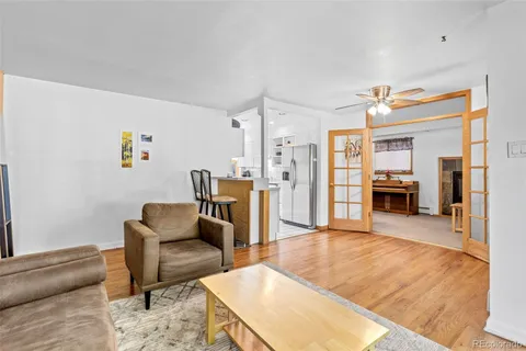 a living room with furniture and kitchen view
