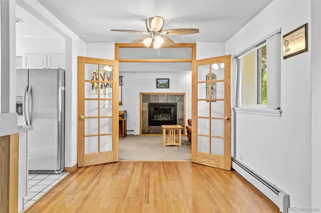 a view of empty room with a fireplace and wooden floor