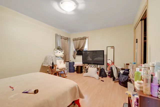 a bed room with a bed a television and a car