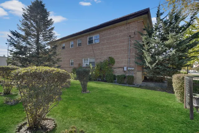 a brick building with a yard