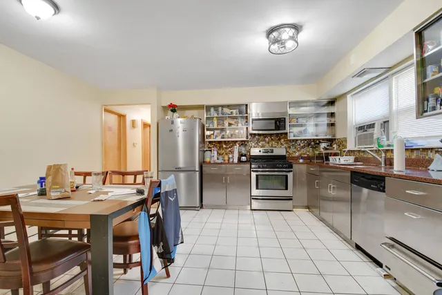 a kitchen with stainless steel appliances a stove a sink and a refrigerator