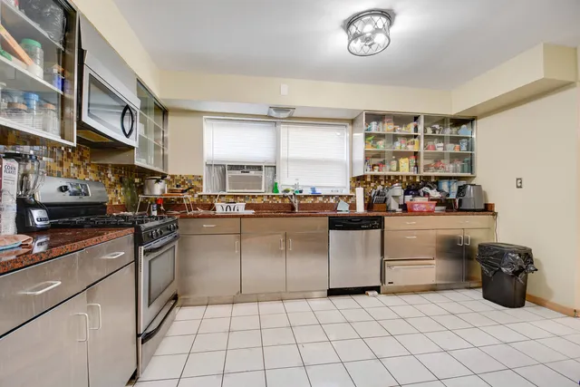 a kitchen with stainless steel appliances granite countertop a sink and cabinets