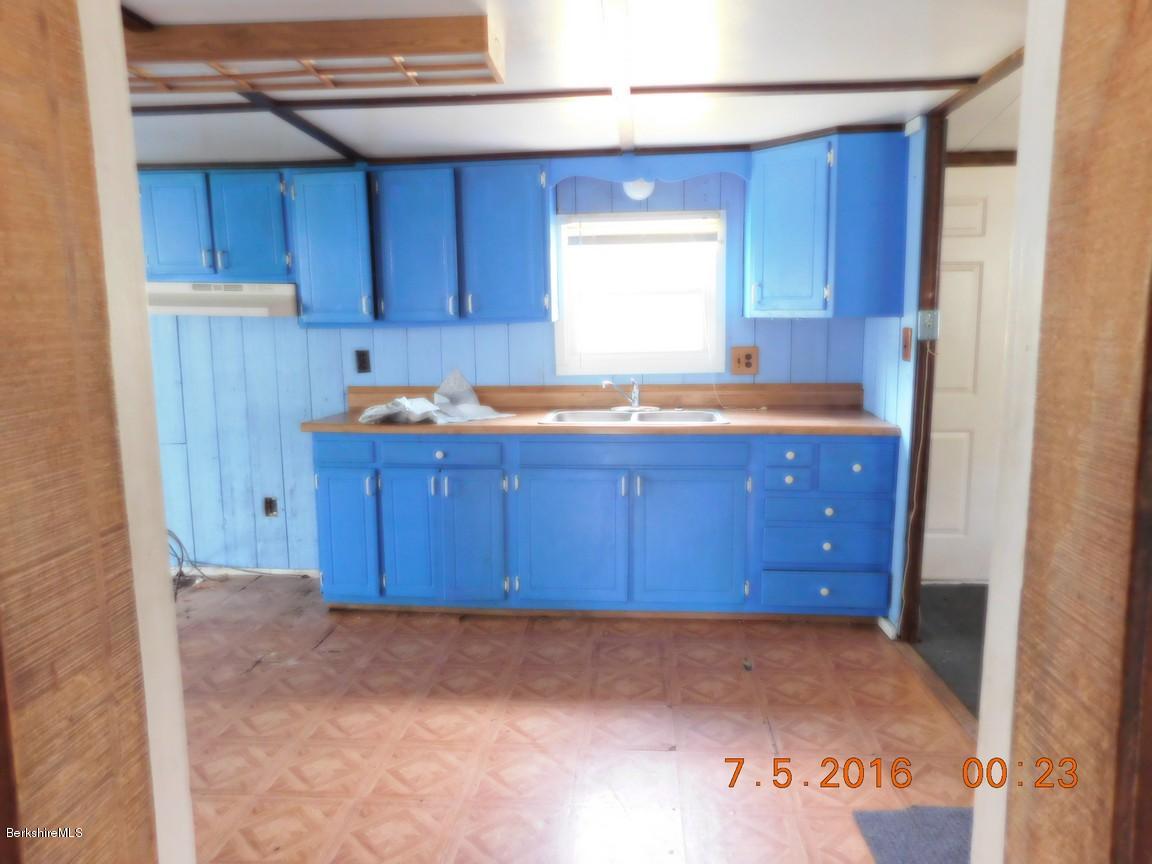 196 Chapel Road Savoy, MA 01256 - Photo 12 of 22 a kitchen with granite countertop wooden cabinets