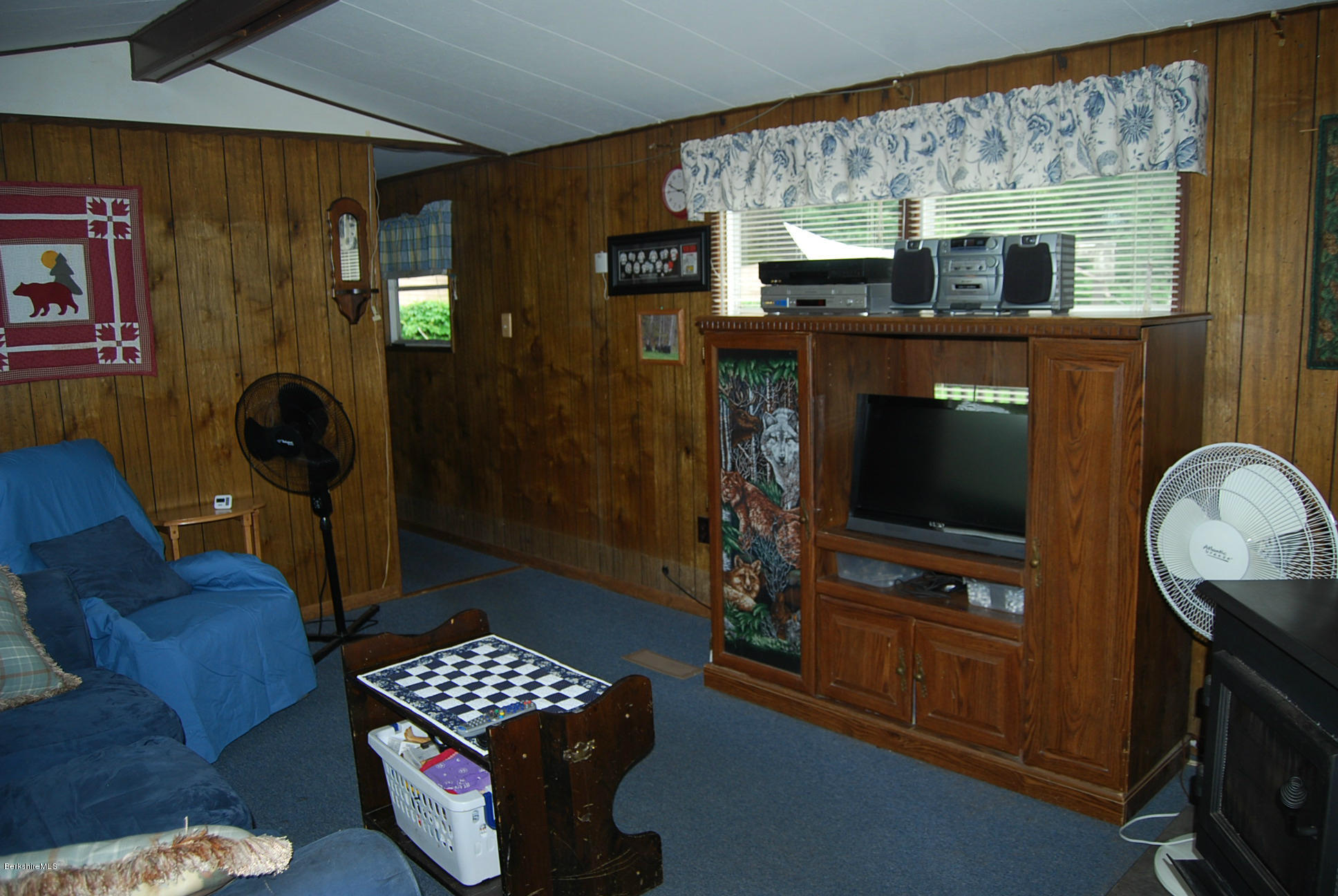 196 Chapel Road Savoy, MA 01256 - Photo 14 of 22 a living room with furniture and a flat screen tv