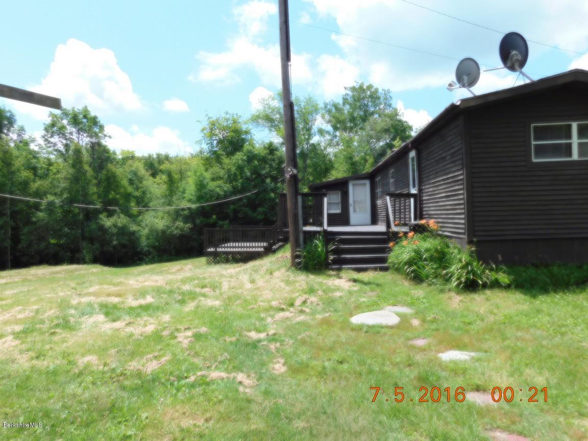 196 Chapel Road Savoy, MA 01256 - Photo 21 of 22 a backyard of a house with plants and wooden fence
