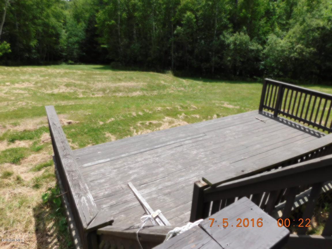 196 Chapel Road Savoy, MA 01256 - Photo 22 of 22 a view of a swimming pool with a chair and tables
