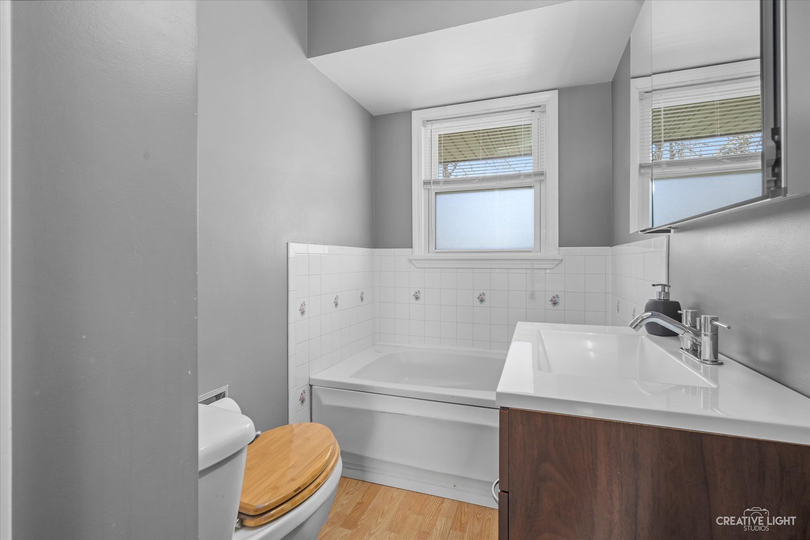 12-n058 Randall Road Elgin, IL 60123 - Photo 12 of 23 a bathroom with a sink a toilet and mirror
