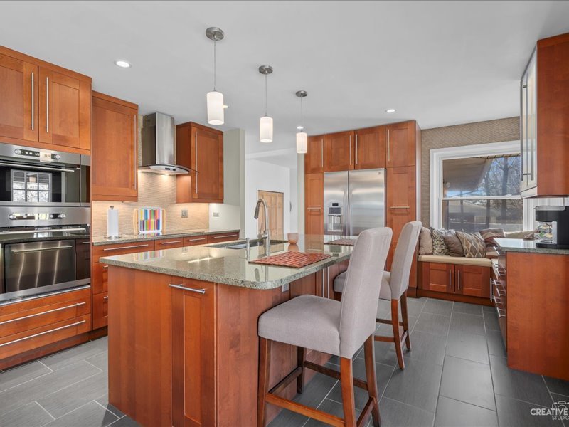 12-n058 Randall Road Elgin, IL 60123 - Photo 6 of 23 a kitchen with stainless steel appliances granite countertop a table chairs and a refrigerator