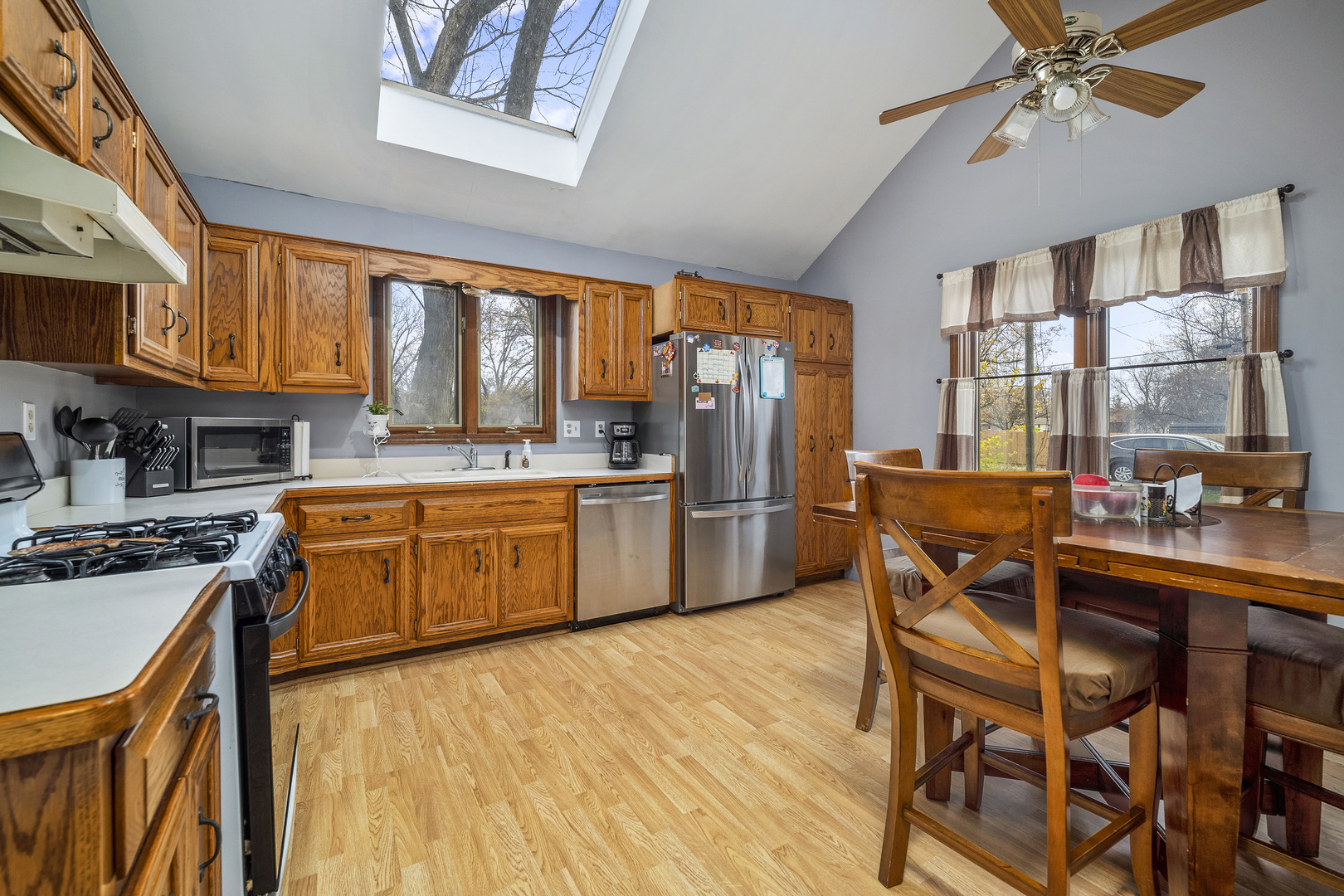 111 East Schmidt Road Braidwood, IL 60408 - Photo 6 of 23 a kitchen with stainless steel appliances granite countertop a stove top oven a sink dishwasher a dining table and chairs with wooden floor