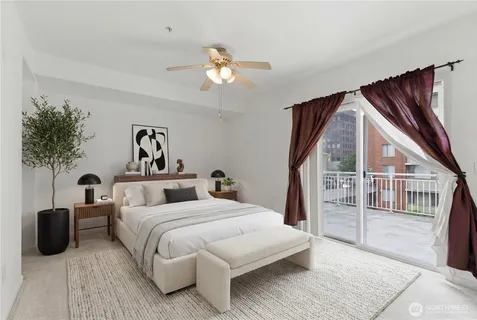 a bedroom with a large bed and a chandelier