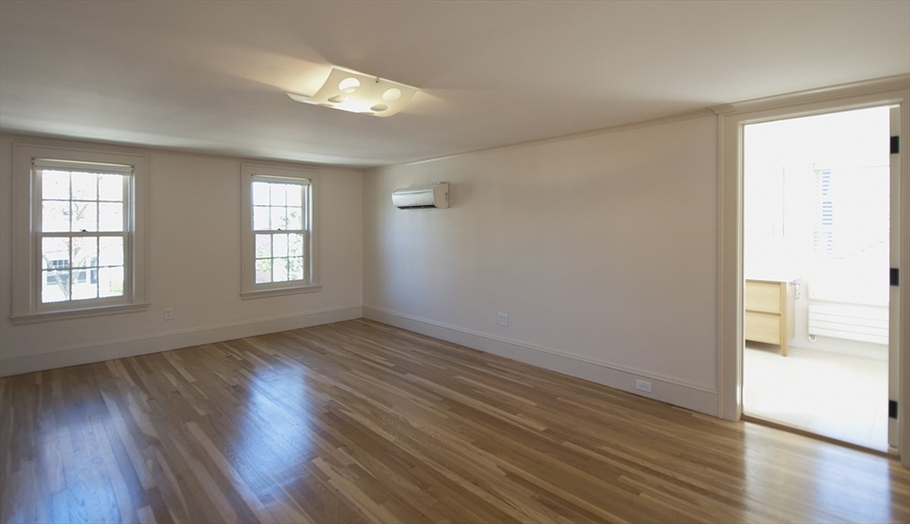 153 Watson Road Belmont, MA 02478 - Photo 8 of 20 an empty room with wooden floor and windows