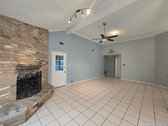 a view of an empty room and fire place