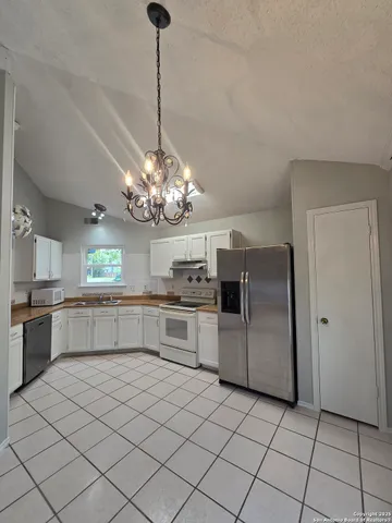 a kitchen with stainless steel appliances a refrigerator sink and cabinets