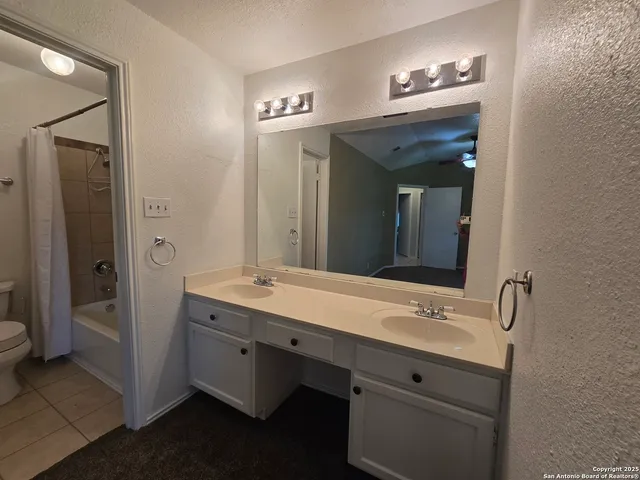 a bathroom with a double vanity sink and mirror