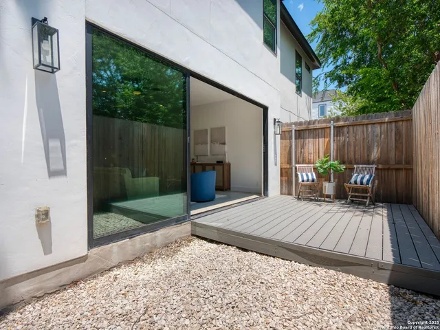 a view of backyard with a patio and outdoor seating