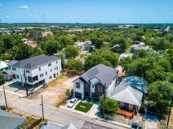 an aerial view of multiple houses with a yard