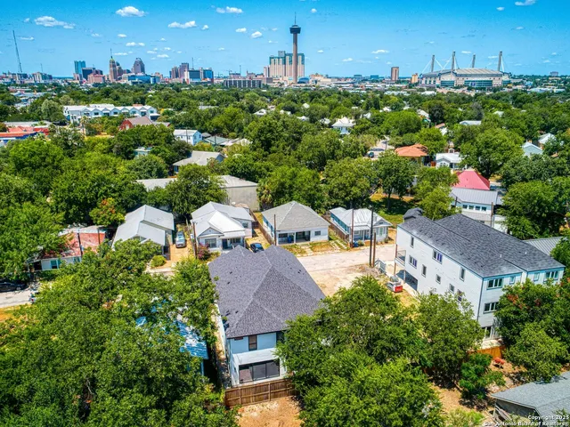 an aerial view of multiple houses with yard