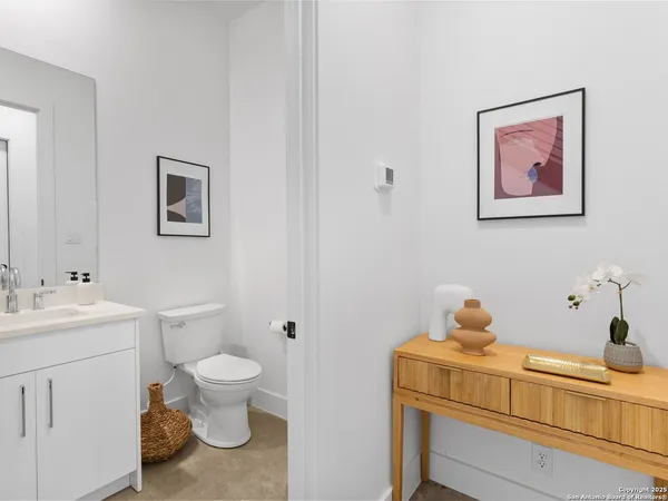 a bathroom with a toilet sink and mirror
