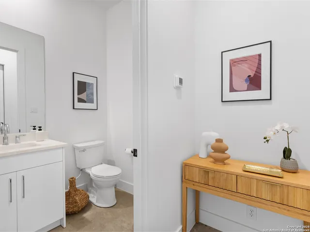 a bathroom with a toilet sink and mirror