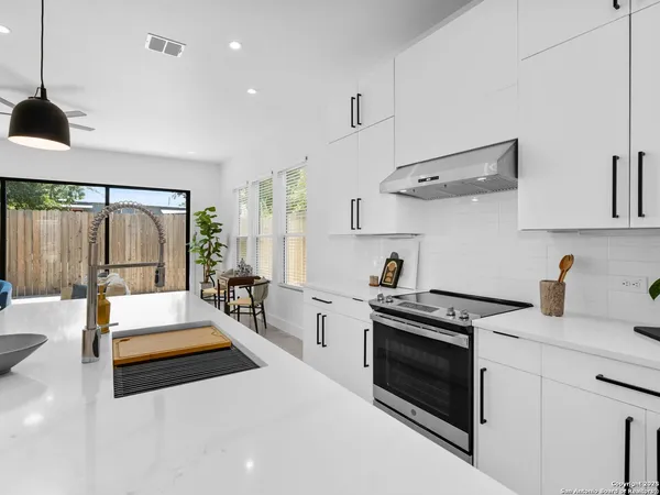 a kitchen with stove and refrigerator
