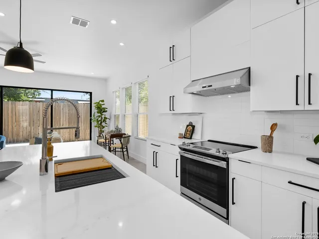 a kitchen with stove and refrigerator