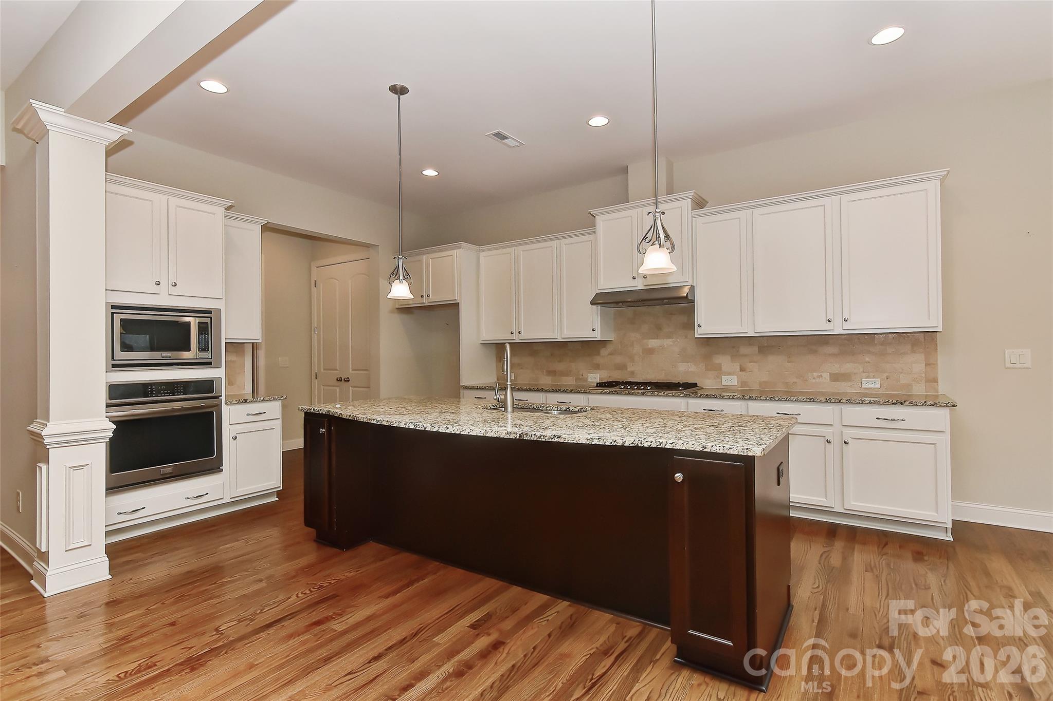 2287 Sweet Clover Way Denver, NC 28037 - Photo 14 of 44 a kitchen with granite countertop a sink cabinets and stainless steel appliances