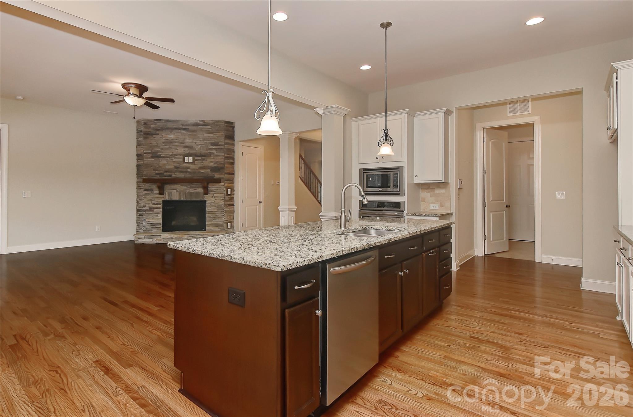 2287 Sweet Clover Way Denver, NC 28037 - Photo 16 of 44 an open kitchen with a sink and breakfast area