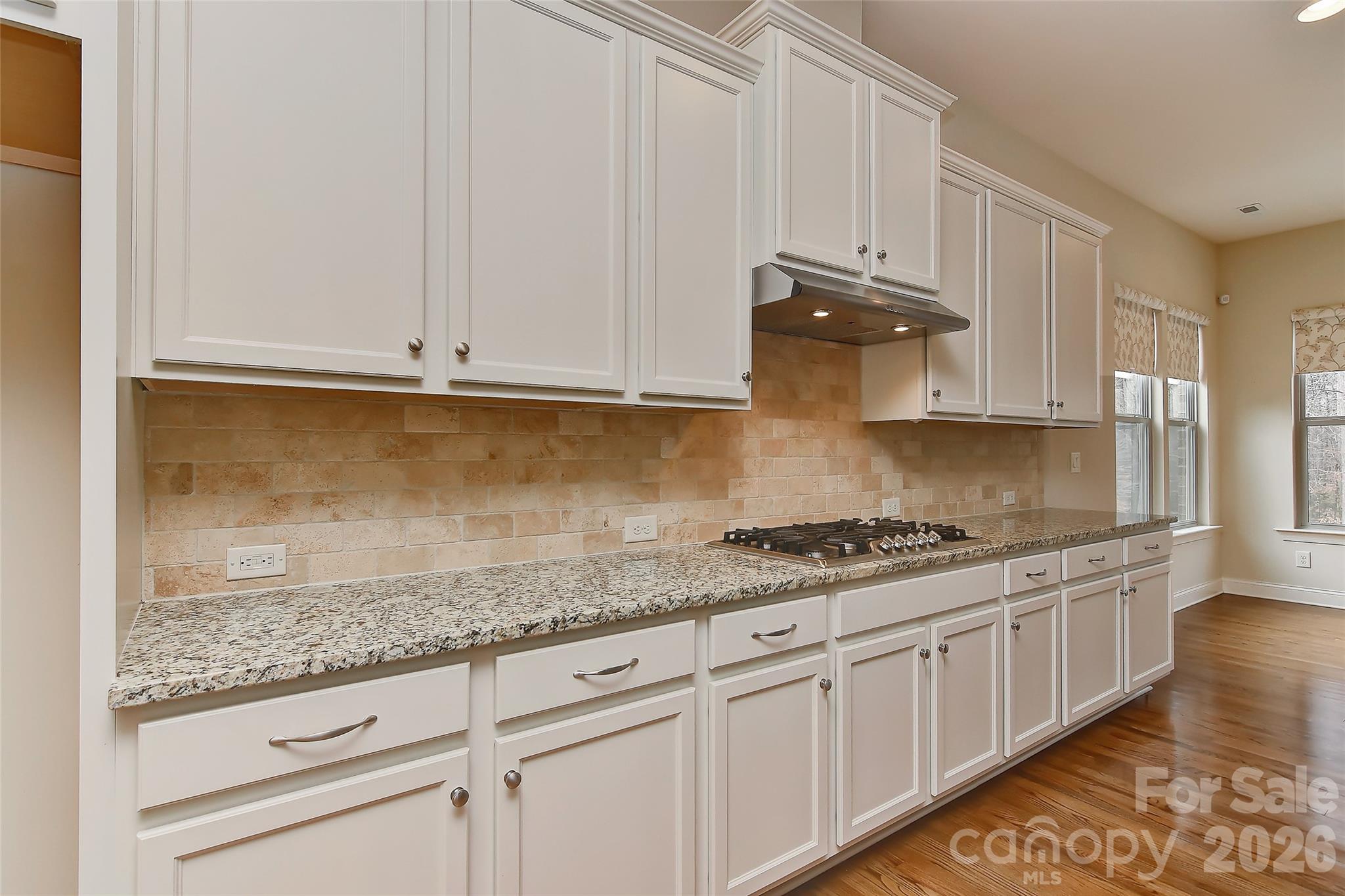 2287 Sweet Clover Way Denver, NC 28037 - Photo 17 of 44 a kitchen with granite countertop white cabinets and a stove