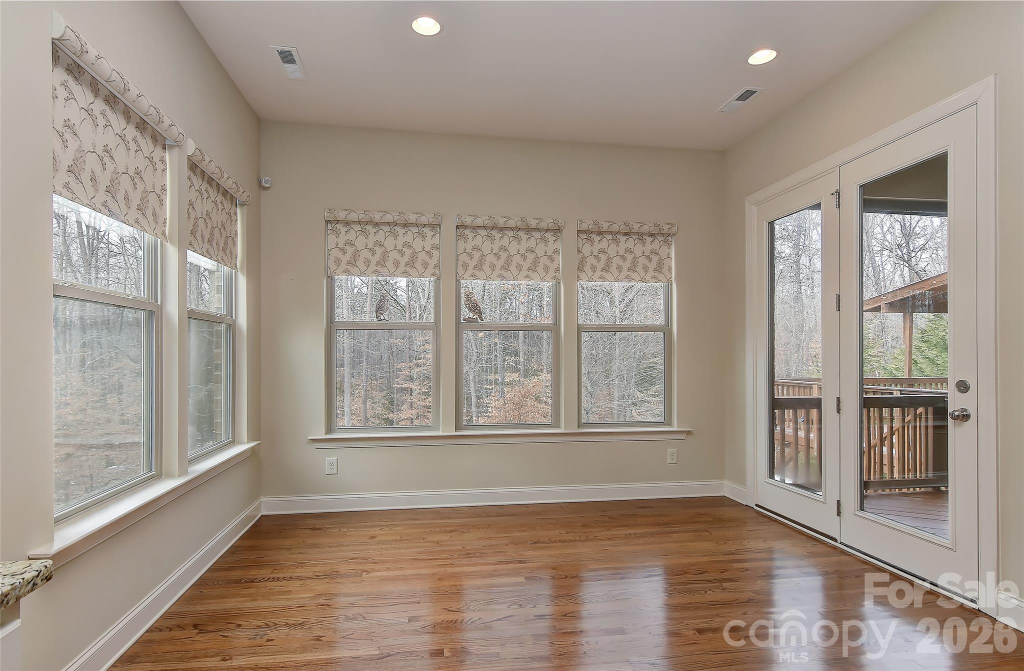 2287 Sweet Clover Way Denver, NC 28037 - Photo 19 of 44 a view of an empty room with a window and wooden floor