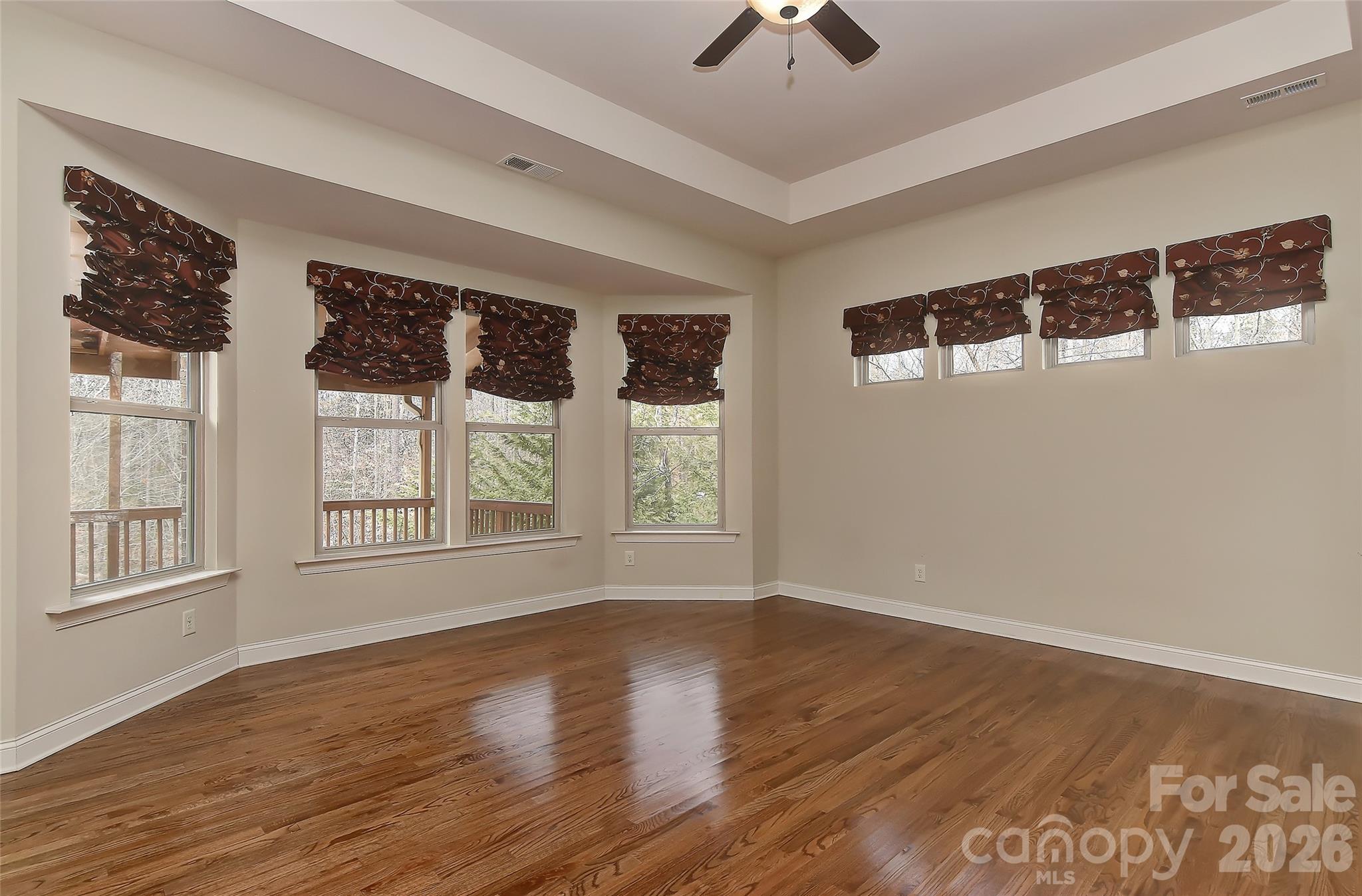 2287 Sweet Clover Way Denver, NC 28037 - Photo 21 of 44 a view of an empty room with a window and wooden floor